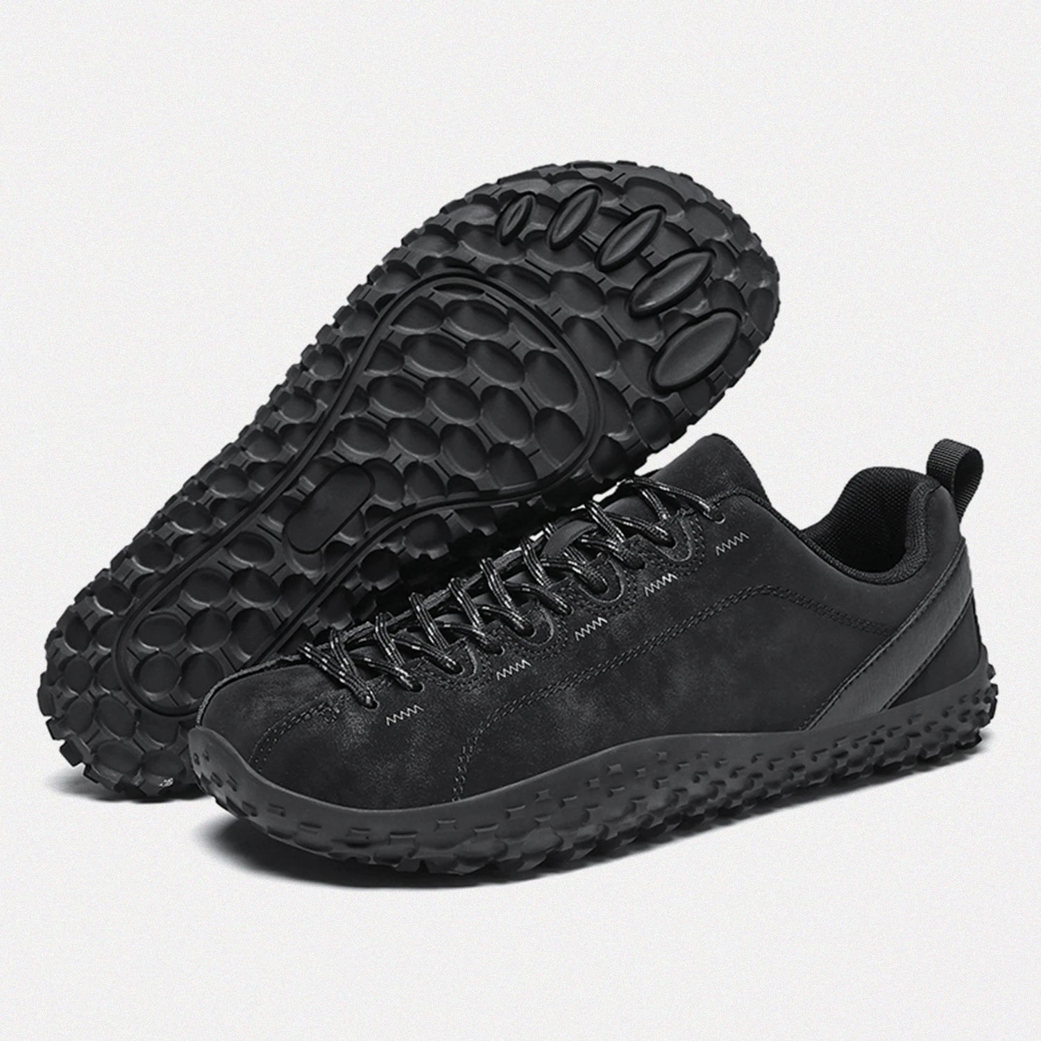 Dannto black barefoot outdoor sneakers shown from a three quarter view and the bottom