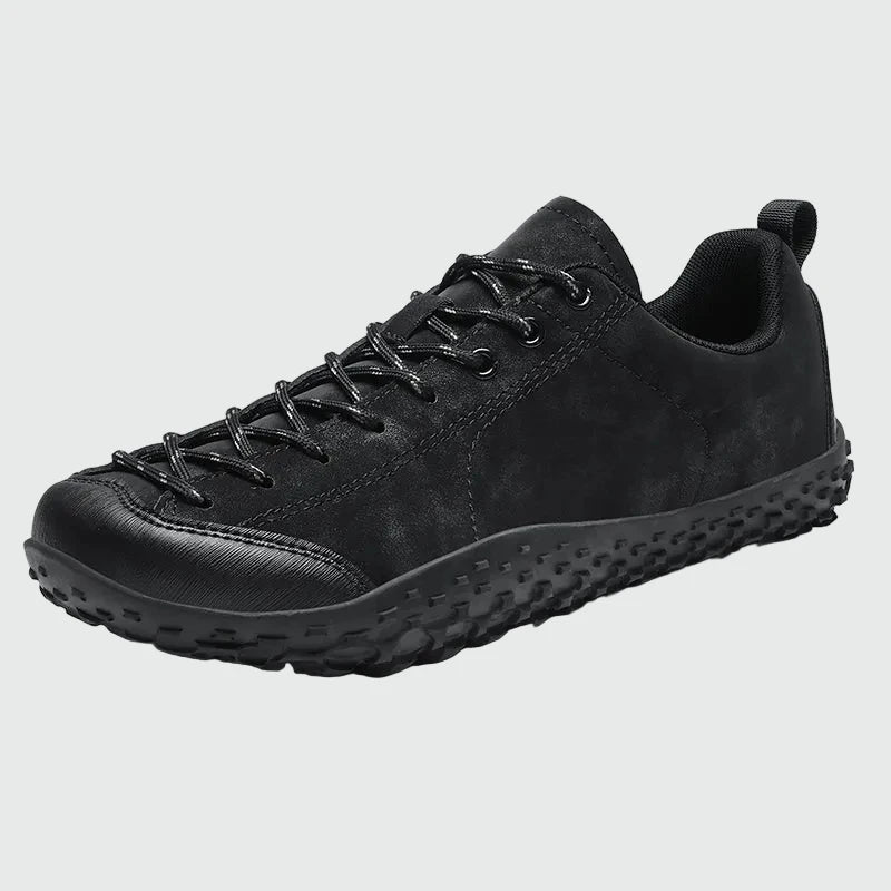 Dannto black barefoot trail shoes shown from a three quarter view
